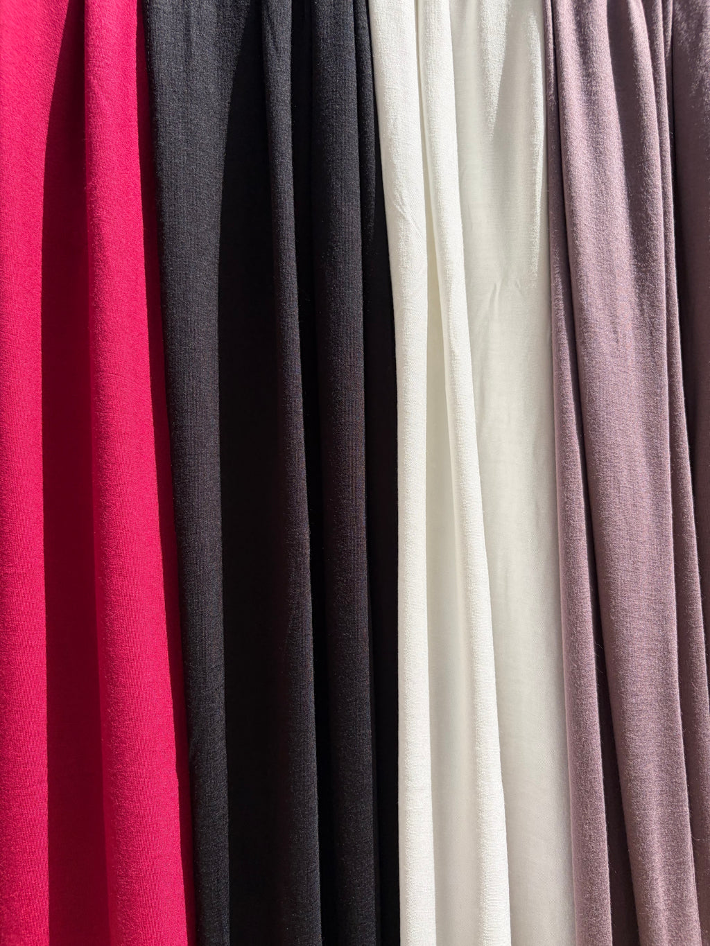 Close up on Jersey set scarf in 4 colors, black, off-white, maroon & deep lilac